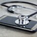 a smart phone with a stethoscope on top of it
