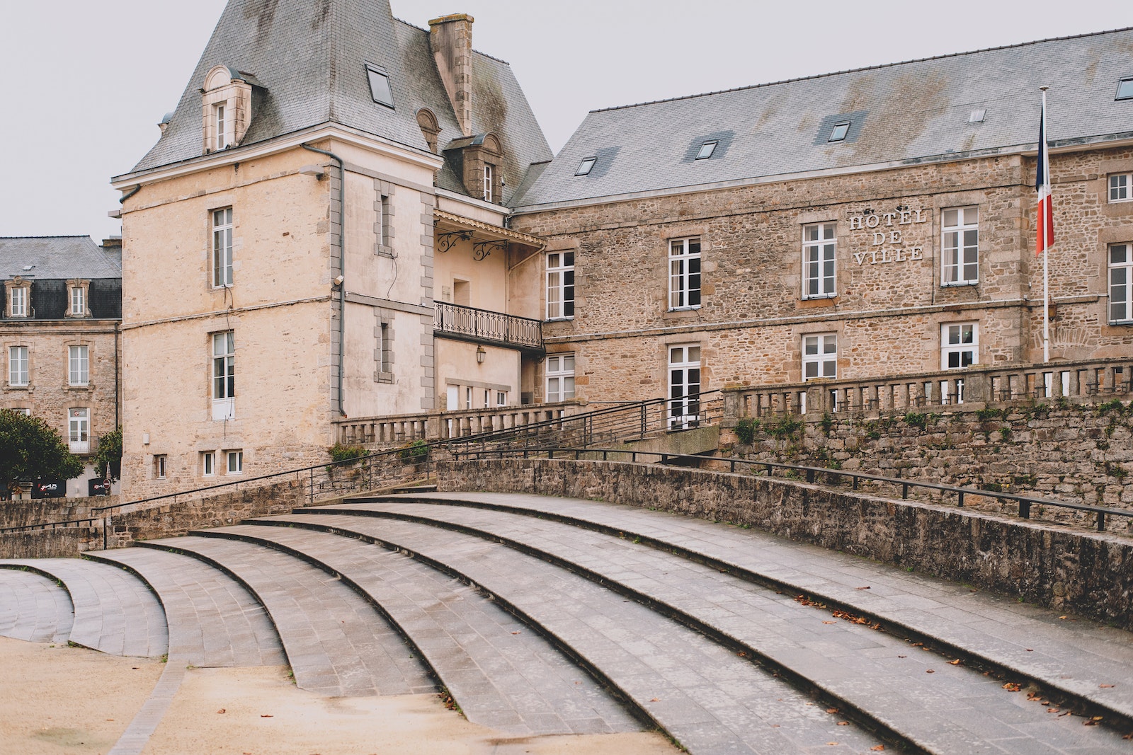 Old stone palace located in medieval town on overcast day