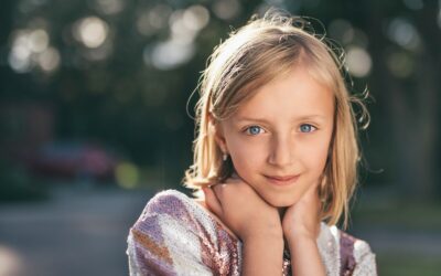 selective focus photography of girl in sequined white-and-pink stripe shirt