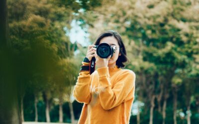 woman holding DSLR camera