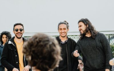 three men standing beside woman